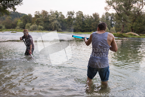 Image of young men having fun with water guns