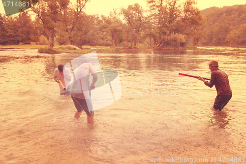 Image of young men having fun with water guns