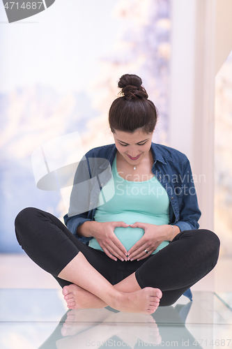 Image of pregnant women sitting on the floor