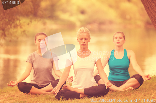 Image of women meditating and doing yoga exercise