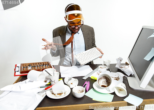 Image of Young man spilled coffee on the keyboard