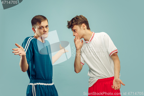 Image of Two young men isolated on blue background