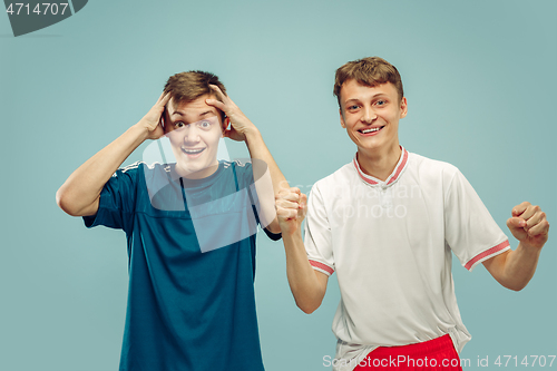 Image of Two young men isolated on blue background