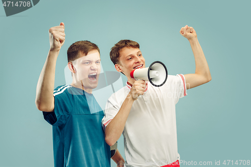 Image of Two young men isolated on blue background