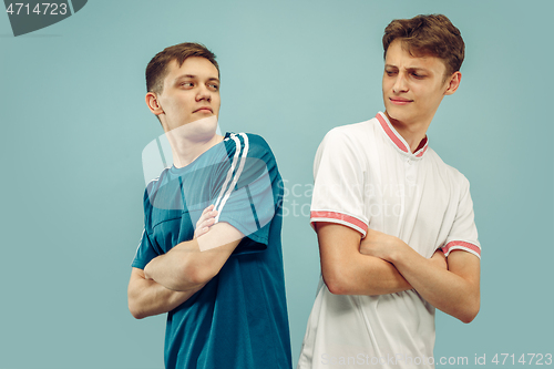 Image of Two young men isolated on blue background