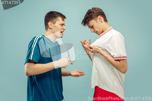 Image of Two young men isolated on blue background