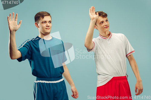 Image of Two young men isolated on blue background