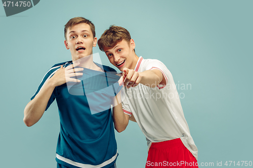 Image of Two young men isolated on blue background