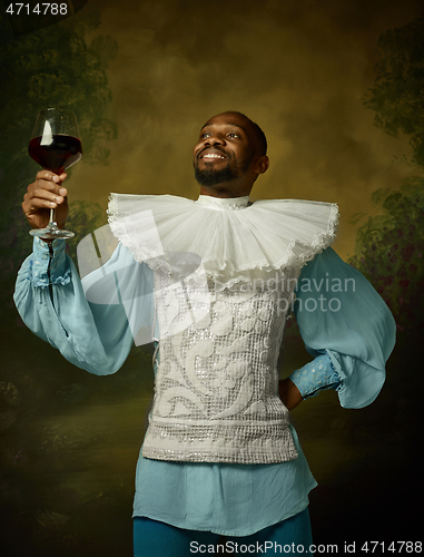 Image of Young man as a medieval knight on dark background