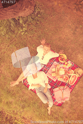 Image of top view of couple enjoying picnic time