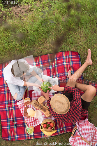 Image of top view of couple enjoying picnic time