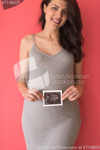 Image of happy pregnant woman showing ultrasound picture