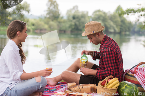 Image of Couple in love enjoying picnic time