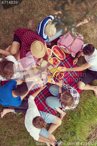 Image of top view of group friends enjoying picnic time