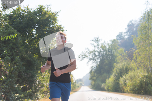 Image of man jogging along a country road