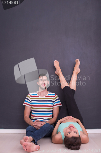 Image of pregnant couple relaxing on the floor