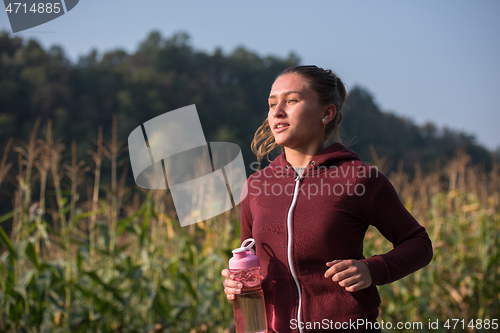 Image of woman jogging along a country road