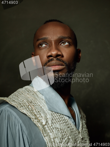 Image of Young man as a medieval knight on dark background