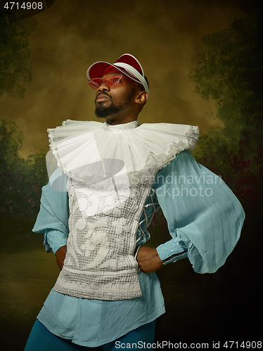 Image of Young man as a medieval knight on dark background