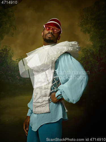 Image of Young man as a medieval knight on dark background