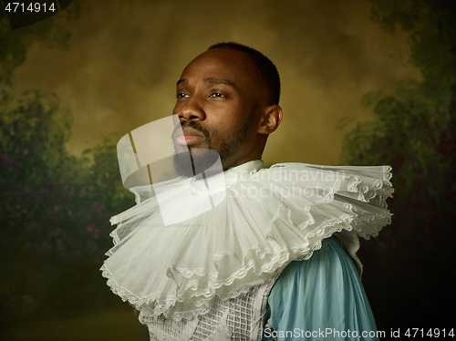 Image of Young man as a medieval knight on dark background