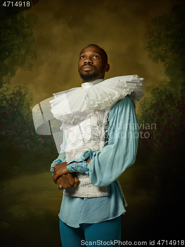 Image of Young man as a medieval knight on dark background