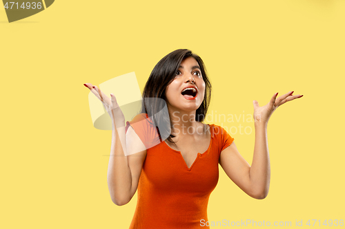 Image of Portrait of beautiful woman isolated on yellow studio background