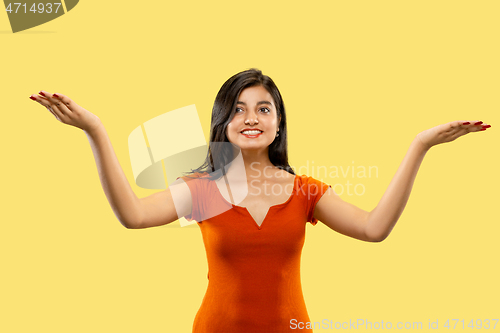 Image of Portrait of beautiful woman isolated on yellow studio background