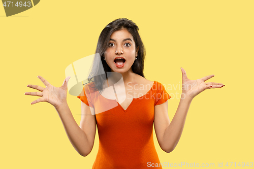 Image of Portrait of beautiful woman isolated on yellow studio background