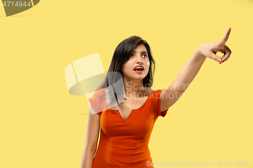 Image of Portrait of beautiful woman isolated on yellow studio background