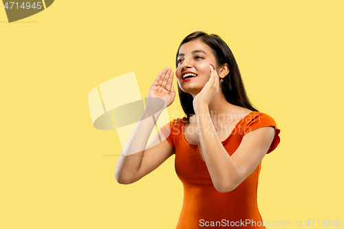 Image of Portrait of beautiful woman isolated on yellow studio background