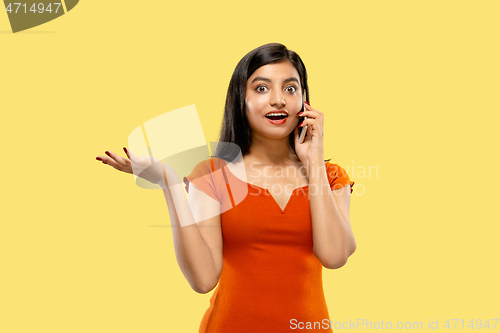 Image of Portrait of beautiful woman isolated on yellow studio background