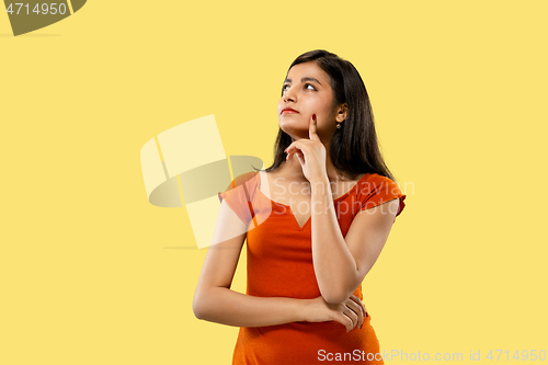 Image of Portrait of beautiful woman isolated on yellow studio background