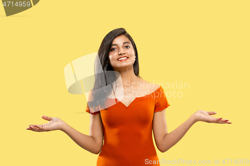 Image of Portrait of beautiful woman isolated on yellow studio background