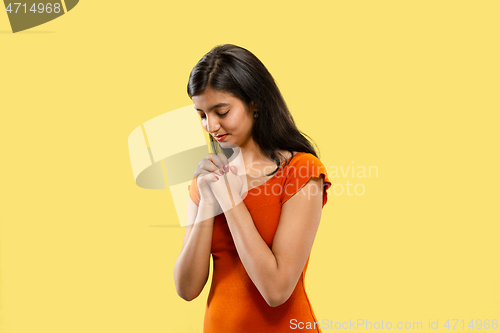 Image of Portrait of beautiful woman isolated on yellow studio background