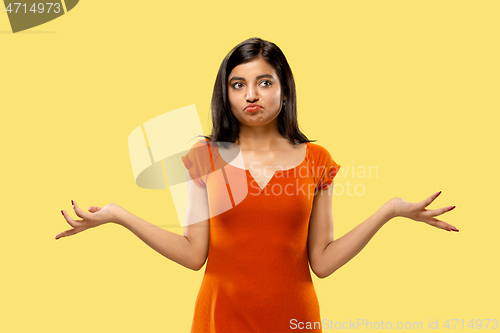 Image of Portrait of beautiful woman isolated on yellow studio background