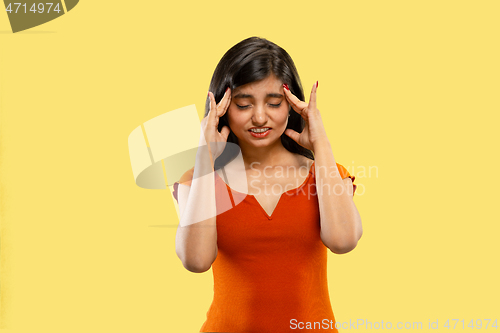 Image of Portrait of beautiful woman isolated on yellow studio background