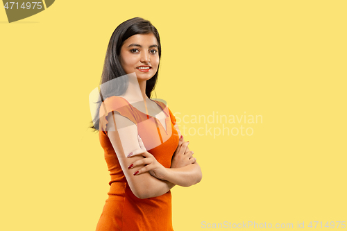 Image of Portrait of beautiful woman isolated on yellow studio background