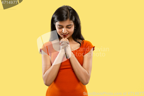 Image of Portrait of beautiful woman isolated on yellow studio background