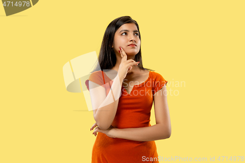 Image of Portrait of beautiful woman isolated on yellow studio background