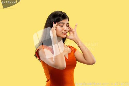 Image of Portrait of beautiful woman isolated on yellow studio background