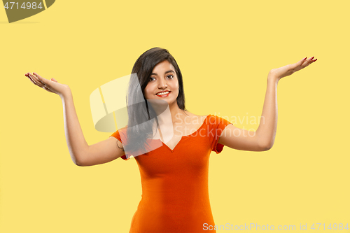 Image of Portrait of beautiful woman isolated on yellow studio background