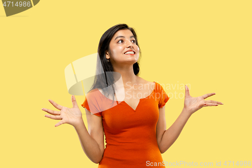 Image of Portrait of beautiful woman isolated on yellow studio background
