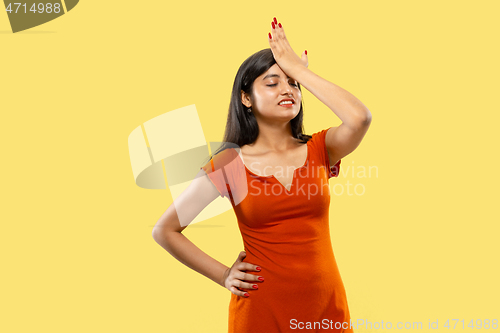 Image of Portrait of beautiful woman isolated on yellow studio background