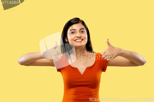 Image of Portrait of beautiful woman isolated on yellow studio background