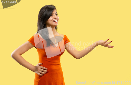 Image of Portrait of beautiful woman isolated on yellow studio background