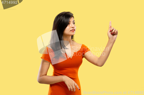 Image of Portrait of beautiful woman isolated on yellow studio background