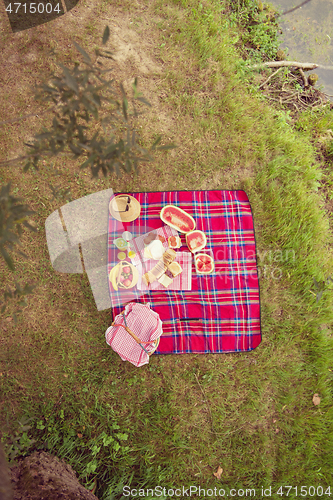 Image of top view of picnic blanket setting on the grass