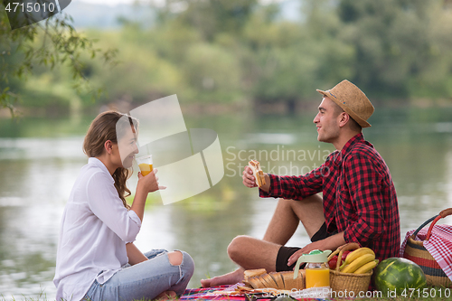 Image of Couple in love enjoying picnic time