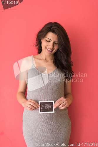 Image of happy pregnant woman showing ultrasound picture